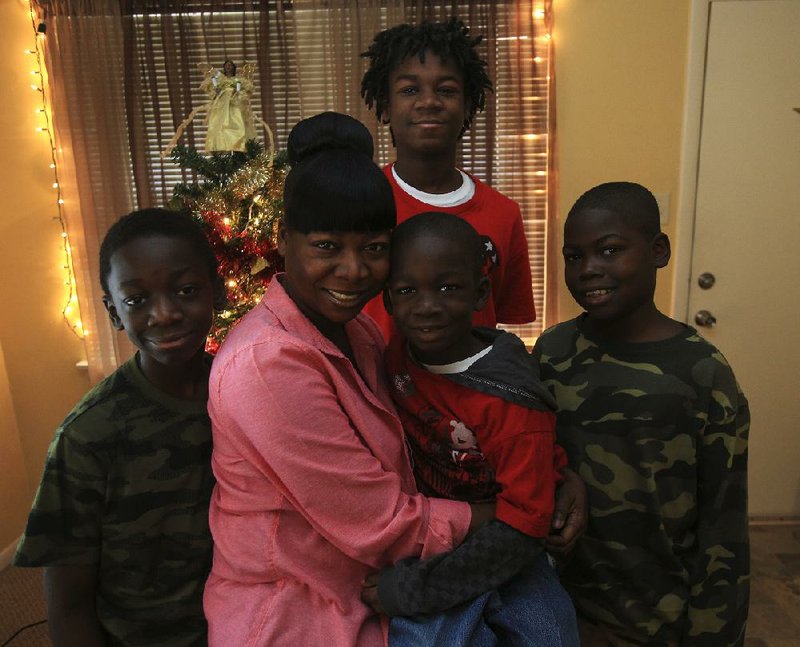 Erica Bullock says the North Little Rock Shop With a Cop program made a big difference for her and her sons, (left to right) Damarco Nicholson, 11, Destin Nicholson, 7, Dejuan Grimes, 10, and Tyjuan Wright (background standing), 16, when they participated in the program in 2012.