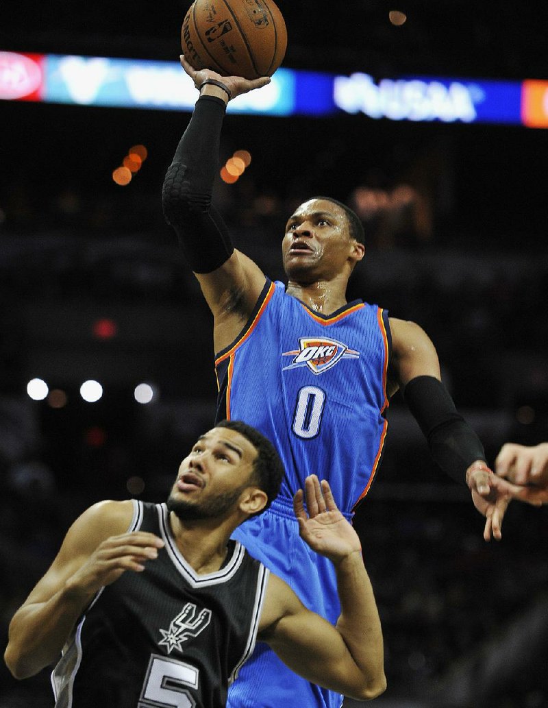 Oklahoma City Thunder guard Russell Westbrook shoots over San Antonio Spurs guard Cory Joseph (5) during the first half of Thrusday’s game in San Antonio. Westbrook had 34 points and the Thunder won 114-106. 