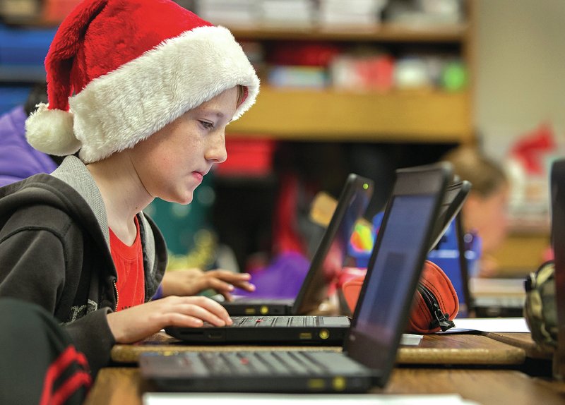 STAFF PHOTO JASON IVESTER Alex Magnusson, Bellview Elementary School fifth-grader, works on a laptop Dec. 18 in class at the Rogers school.