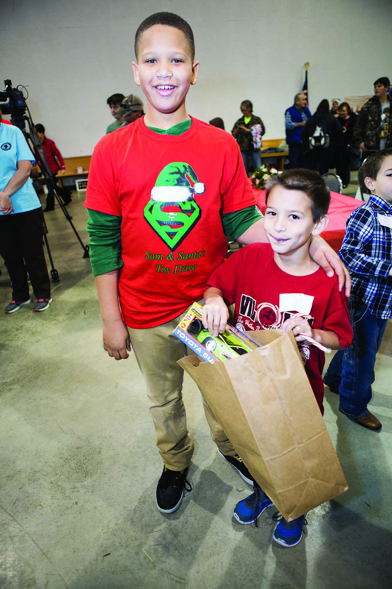 Sam Love, 11, of Chicago poses with Daniel Deal, 9, of Vilonia after handing Daniel a present. It’s the third year for Samuel’s Toy Giveaway. Sam heard on the news about the April 27 tornado that hit Faulkner County, researched the storm online and decided to bring toys to children affected by the tornado. “It feels good knowing you’re helping other kids,” he said.