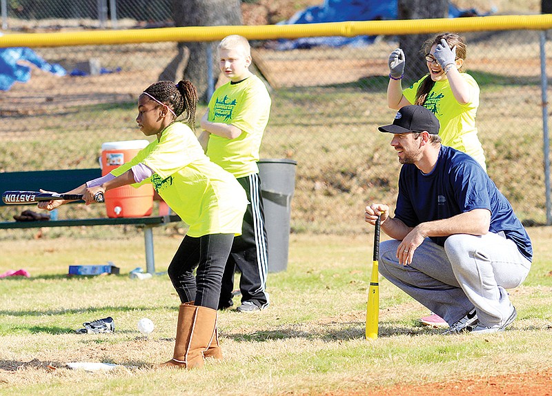 enton native and current Philadelphia Phillies pitcher Cliff Lee, right, watches during a bunting drill at a baseball camp that was sponsored by the Garth Brooks Teammates for Kids Foundation and ProCamps on Dec. 13 at Lamar Porter Field in Little Rock.