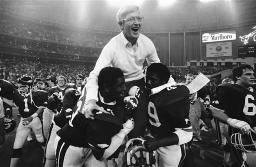 Arkansas coach Lou Holtz gets a victory ride on the shoulders of Earl Buckingham (73) and Milton Fields (49) on Friday, Dec. 31, 1982 in Houston after his Razorbacks won the Bluebonnet Bowl game from Florida by a score of 28-24. (AP Photo)