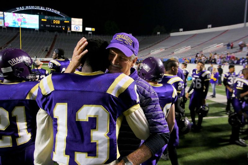 12/13/14
Arkansas Democrat-Gazette/STEPHEN B. THORNTON
Junction City's head coach David Carpenter embraces player Akeem Gibson  after winning their 2A state championship football game Saturday night at War Memorial Stadium in Little Rock. Junction City vs. Hazen