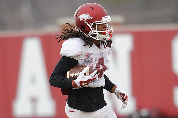 Arkansas receiver Keon Hatcher catches a pass during practice Saturday, Dec. 13, 2014, at the university's practice facility in Fayetteville.