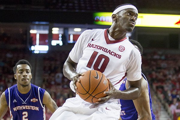 Arkansas forward Bobby Portis, center, spins to the hoop during the first half of an NCAA college basketball game against Northwestern State on Sunday, Dec. 28, 2014, in Fayetteville, Ark. Arkansas won 100-92. (AP Photo/Gareth Patterson)