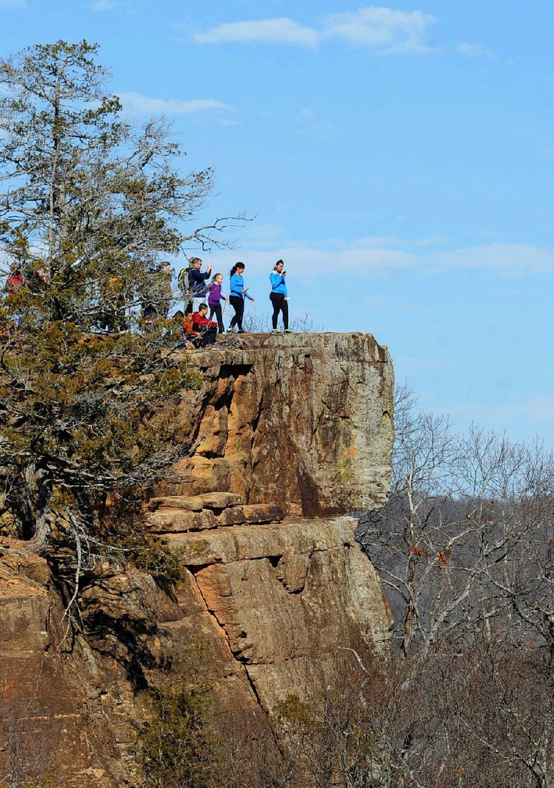 NWA Media/ANDY SHUPE - A group of hikers enjoys the view from the Yellow Rock lookout Saturday, Dec. 28, 2013, while on a hike along the Yellow Rock Trail. "First Day Hikes" are scheduled at Arkansas State Parks on Wednesday to help people start the new year with an experience outside.