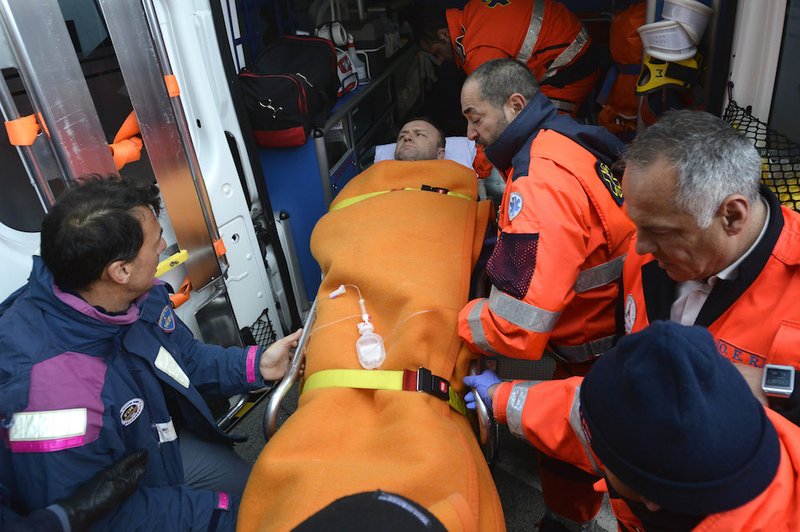 Rescuers assist a passenger of the Italian-flagged Norman Atlantic, that caught fire in the Adriatic Sea, in Bari harbor, southern Italy, on Monday, Dec. 29, 2014. A ferry carrying nearly 500 people caught fire off the Greek island of Corfu early Sunday, trapping passengers on the top decks as gale-force winds and choppy seas hampered the evacuation. Greek and Italian rescue helicopters and vessels struggled to reach the stricken ferry, with nearby merchant ships lining up to form a wall against the raging gusts. 