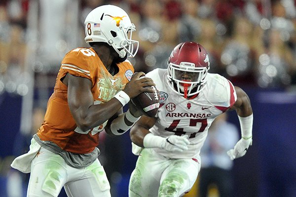 Arkansas linebacker Martrell Spaight pressures Texas quarterback Tyrone Swoopes during the first half of the Texas Bowl on Monday, Dec. 29, 2014 at NRG Stadium in Houston. 
