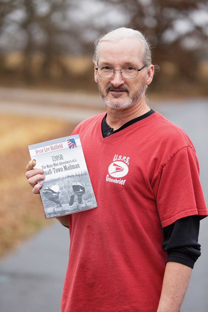 Jesse Lee Hatfield of Conway holds a copy of his book, 72058: The Many Mini Adventures of a Small-Town Mailman, about his experiences as a mail carrier for the Greenbrier Post Office. Hatfield also used anecdotes from his wife, Suzy, a relief, or substitute, mail carrier in Greenbrier, and from his co-workers.