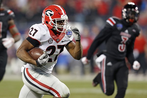 Georgia's Nick Chubb (27) runs for a touchdown against Louisville during the first half of the Belk Bowl NCAA college football game in Charlotte, N.C., Tuesday, Dec. 30, 2014. (AP Photo/Nell Redmond)