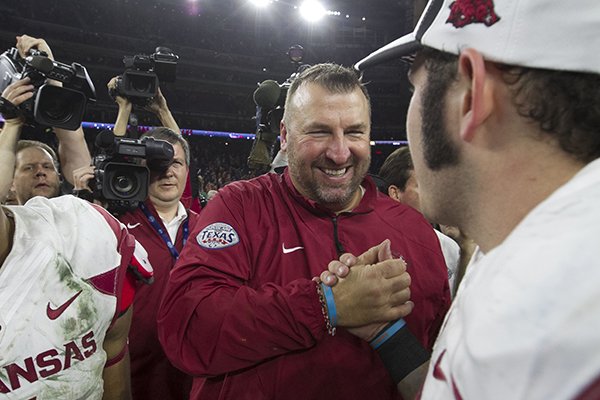 Arkansas coach Bret Bielema celebrates with players following the Razorbacks' 31-7 win over Texas in the Texas Bowl on Monday, Dec. 29, 2014 at NRG Stadium in Houston. 