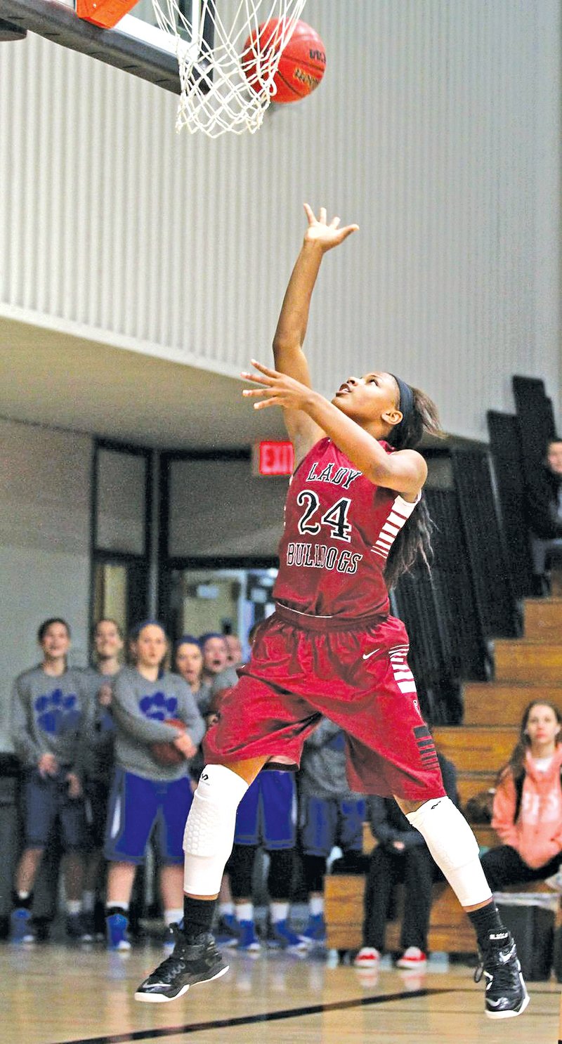 Special To NWA Media SAMANTHA BAKER Chasidee Owens of Springdale High makes a layup to put the Lady Bulldogs in the lead with :07 seconds left during the game against McDonald County on Tuesday at the 60th annual Neosho Holiday Classic at Neosho, Mo.