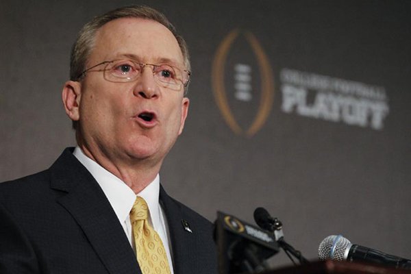 Jeff Long, College Football Playoff selections committee chairman, discusses the selection process of the semifinal pairings and semifinal bowl assignments during a news conference Sunday, Dec. 7, 2014, in Grapevine, Texas. (AP Photo/Tim Sharp)