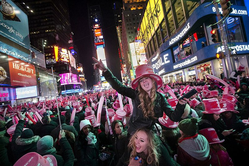 Katlyn Bond of Somers, N.Y., cheers in Times Square during a New Year’s Eve celebration in New York. Thousands braved the cold to watch the annual ball drop and to ring in the new year. Revelers around the world gathered to usher in 2015. 