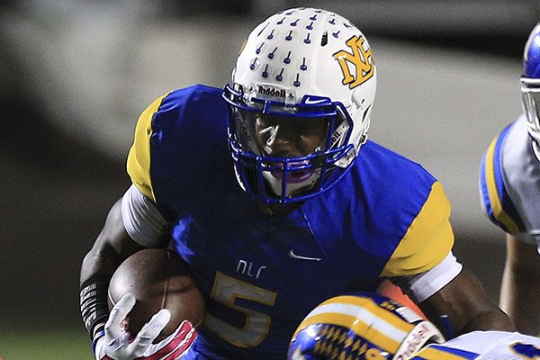 North Little Rock receiver K.J. Hill runs through Mountain Home defenders during a game Thursday, Oct. 2, 2014 at War Memorial Stadium in Little Rock. 