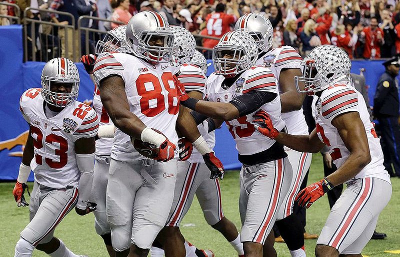 Ohio State’s Steve Miller gets hero’s treatment from teammates at the Superdome on Thursday night after intercepting a pass from Alabama quarterback Blake Sims and returning it 44 yards for a touchdown. Miller’s touchdown gave Ohio State a 34-21 lead late in the third quarter after Alabama led 21-6 in the first half. 