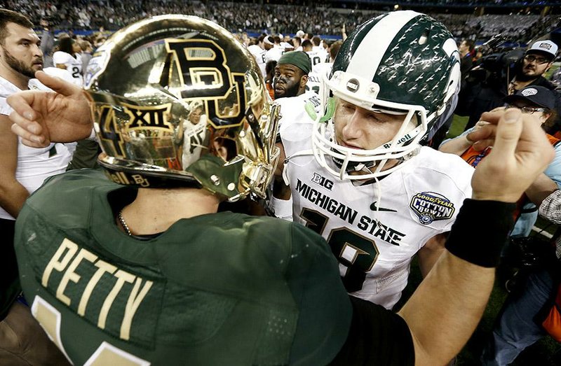 Michigan State quarterback Connor Cook (right) greets Baylor quarterback Bryce Petty after the Cotton Bowl in Arlington, Texas. Petty threw for 550 yards and 3 touchdowns Thursday, while Cook finished with 314 yards passing and 2 touchdowns, both of which came in the fourth quarter as Michigan State rallied to defeat Baylor 42-41. 