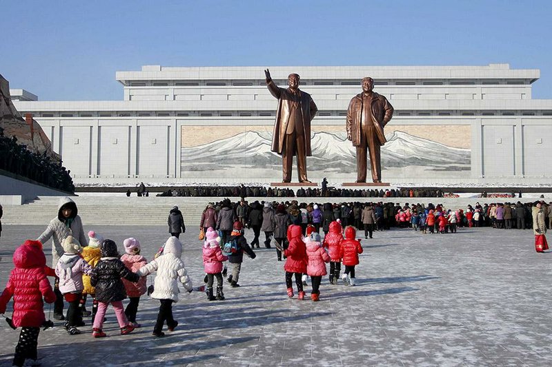 North Koreans gather Dec. 16 at Mansu Hill, where the statues of the late leaders Kim Il Sung and Kim Jong Il tower over them, in Pyongyang, North Korea. President Barack Obama signed an executive order Friday authorizing sanctions on North Korea in retaliation for the cyberattack against Sony Pictures Entertainment. 