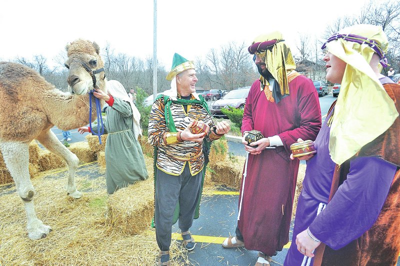 STAFF PHOTO MICHAEL WOODS &#8226; @NWAMICHAELW Dave Brashinger, from left, Troy Strauss and Eric McCalla play their roles as Magi as visitors walk through the living Nativity scene last month at the Bella Vista Christian Church. Epiphany &#8212; celebrated Sunday &#8212; marks the day the Magi arrived, bringing baby Jesus gifts of gold, frankincense and myrrh. Although the names of the Magi are not listed in the Bible, tradition calls them Gaspar, Balthasar and Melchior.
