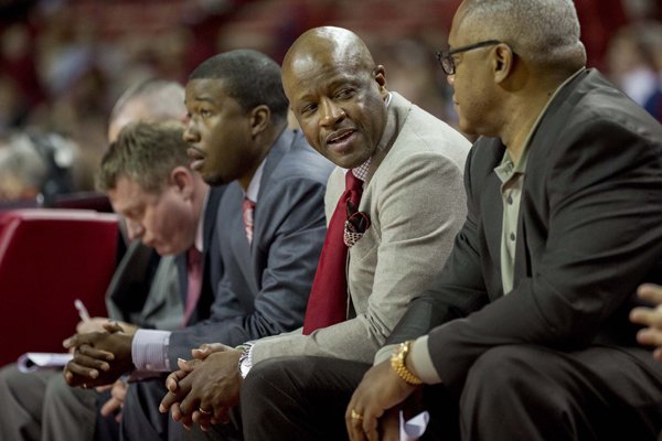 Arkansas head coach Mike Anderson, second from right, talks to his assistant coaches from his bench during the second half of an NCAA college basketball game against Utah Valley on Saturday, Jan. 3, 2015, in Fayetteville, Ark. Arkansas defeated Utah Valley 79-46. (AP Photo/Gareth Patterson)