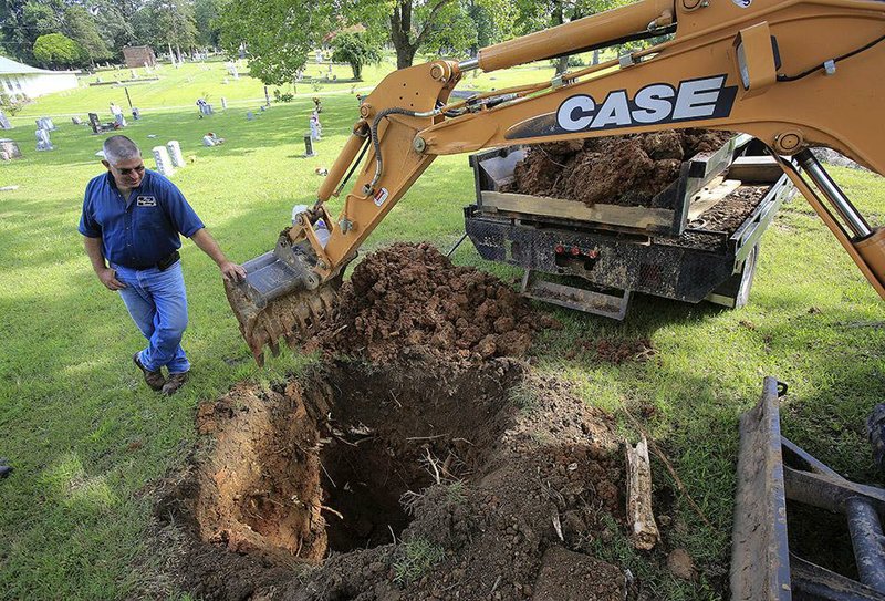 John Rains, sexton at Oakland-Fraternal Historic Cemetery in Little Rock, observes a test dig in July in an old potter’s field at the cemetery. The dig was conducted to help determine whether grave sites sold by the cemetery were previously used. 