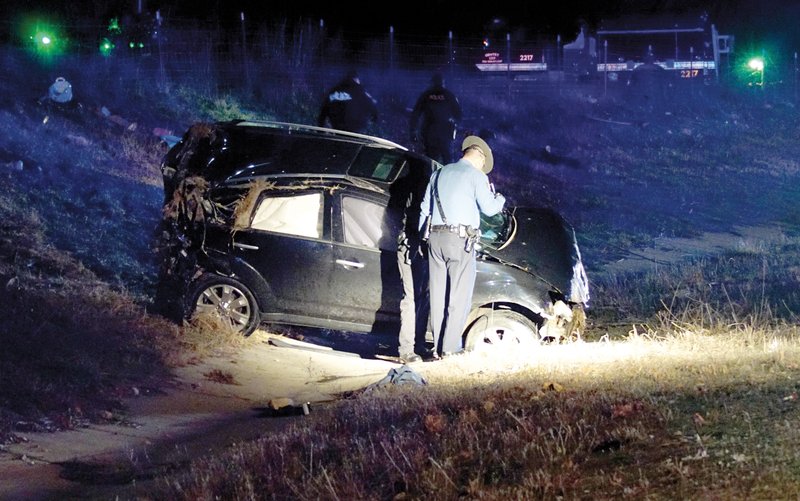 State police, assisted by Gentry police, investigate a single-vehicle rollover accident on Sunday night, on Arkansas Highway 59 south of Gentry, in which the driver was reportedly pinned under the vehicle.
