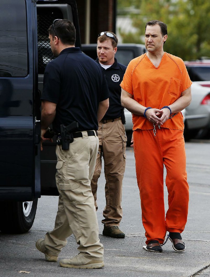 NWA Media/DAVID GOTTSCHALK - 10/28/14 - Former Northwest Arkansas developer Brandon Barber is escorted out of the Federal Courthouse in Fort Smith Tuesday October 28, 2014 following his sentence of five years plus five months in prison for his role in real estate schemes in which he lied about the value of real estate to get inflated loans and later hid assets during his bankruptcy.