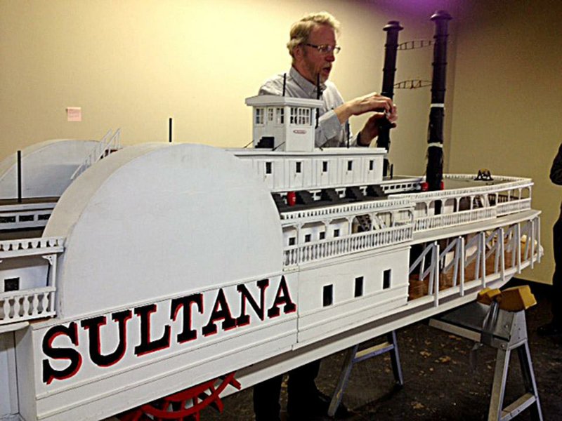 Gene Salecker unwraps tape on the smokestack of his Sultana steamship replica. Salecker will give his 14-foot model to a Marion museum that features the ship's history. (Kenneth Heard/ ARKANSAS DEMOCRAT-GAZETTE) Dec. 29 2014