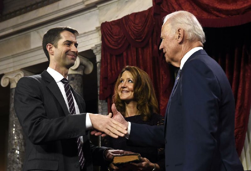 New U.S. Sen. Tom Cotton, R-Ark., is congratulated by Vice President Joe Biden after a ceremonial swearing-in Tuesday in the Old Senate Chamber. Cotton’s wife, Anna, watches the exchange. 
