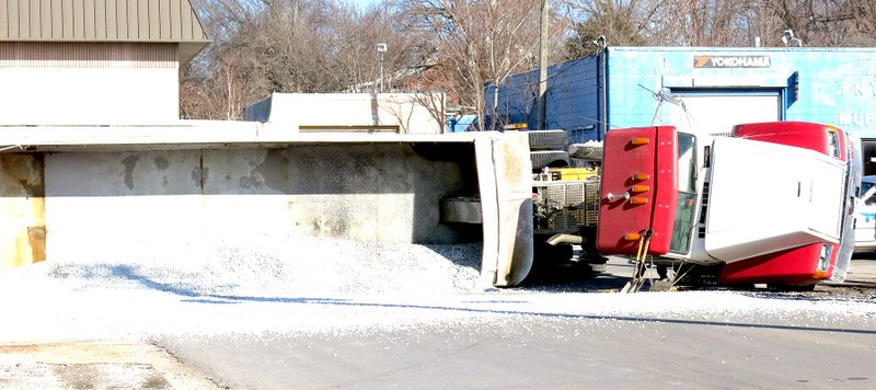 Photo by Mike Eckels A gravel truck belonging to Neosho Trucking, Neosho, Mo., overturned Dec. 29 near the corner of S. Main Street and Third Street in Decatur, spilling its contents.