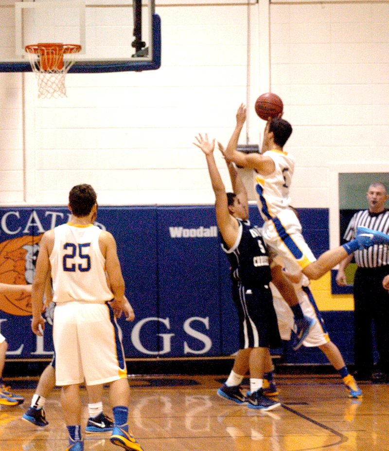 Photo by Mike Eckels Bulldog player Mario Urquidi (#5) ties for a jumper against an Eagle during the Decatur/Union Christian game Jan. 2. Decatur won the game 47 to 29.