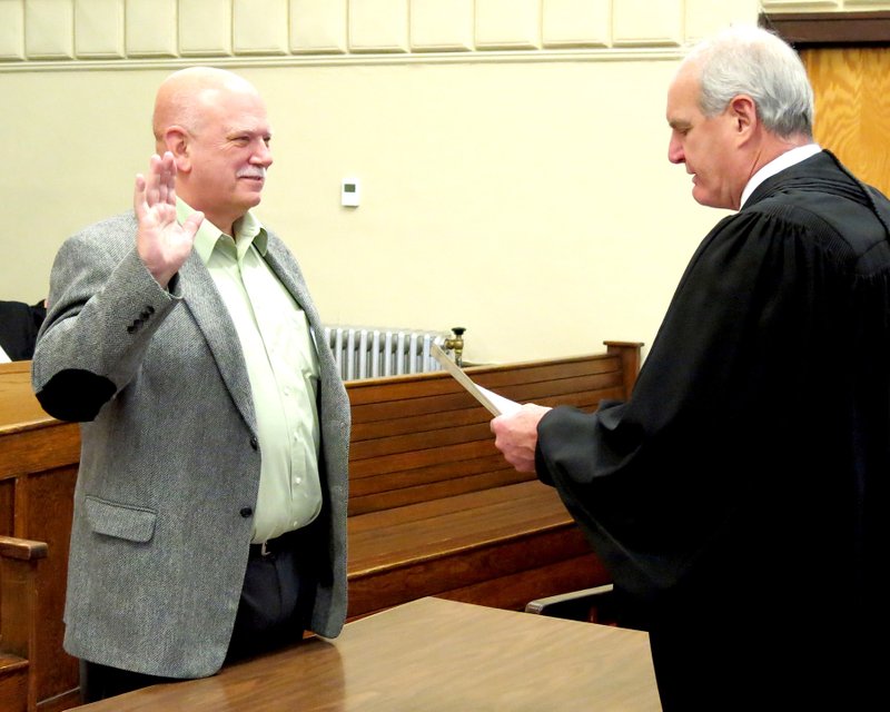 Photo by Mike Eckels New Decatur Mayor Bob Tharp takes his oath of office Jan. 1 . The oath was administered by Judge Doug Schrantz in the Division 1 courtroom at the Benton County Courthouse.