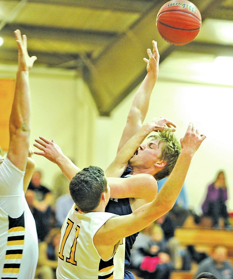  Staff Photo Michael Woods Parker Galligan, left, Prairie Grove defender, tries to block the shot of Shiloh Christian&#8217;s Hunter Wilson as he drives to the basket during Tuesday&#8217;s game at Prairie Grove.