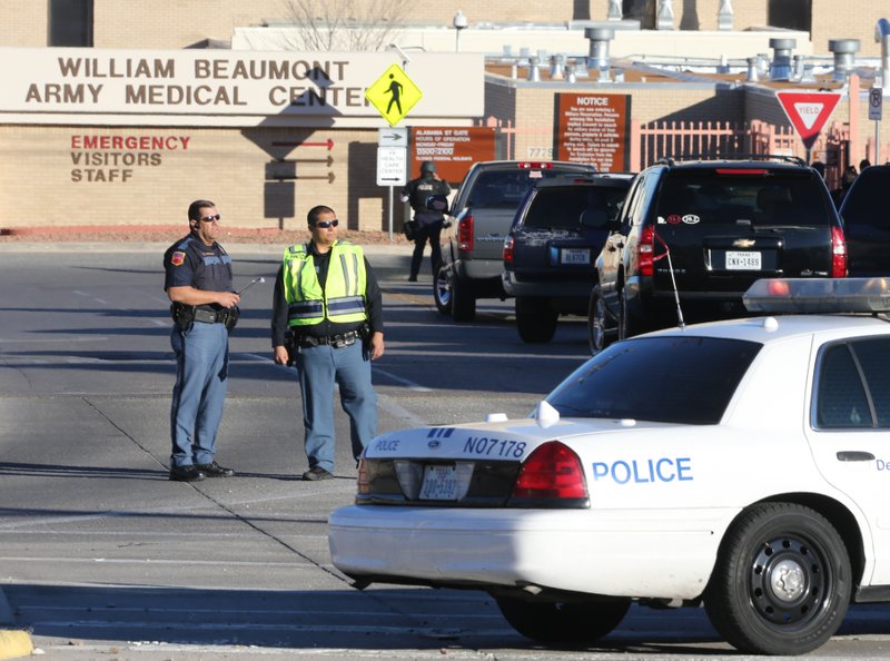 Police officers guard an entrance to the Beaumont Army Medical Center/El Paso VA campus during the search for a gunman Tuesday, Jan. 6, 2014. 