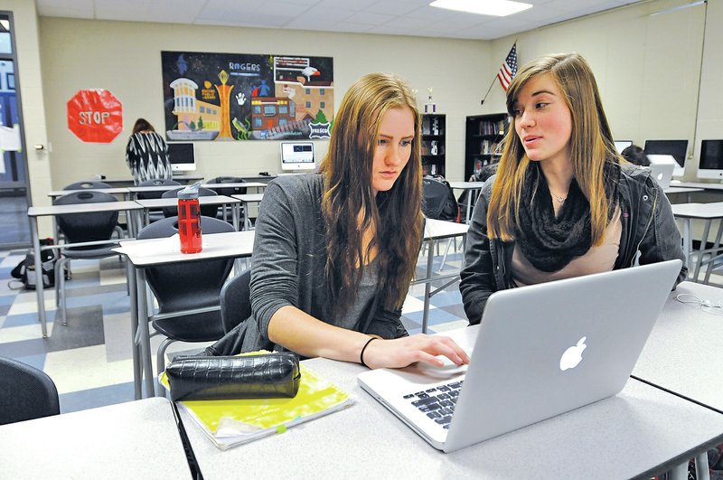 Staff Photo J.T. Wampler Johanna Hegenbart, left, and Katy Rose work Wednesday editing footage filmed at Springdale&#8217;s Northwest Technical Institute. Film students at Rogers Heritage High School are working on several promotional videos for the Springdale school as part of a project.