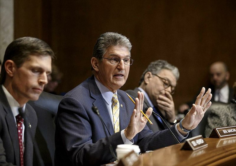 Sen. Joe Manchin (second from left), D-W.Va., a Democratic sponsor of the Keystone XL pipeline bill, makes his plea Thursday for the legislation before the Senate Energy and Natural Resources Committee. Sen. Al Franken, D-Minn., (second from right) opposes the bill. 