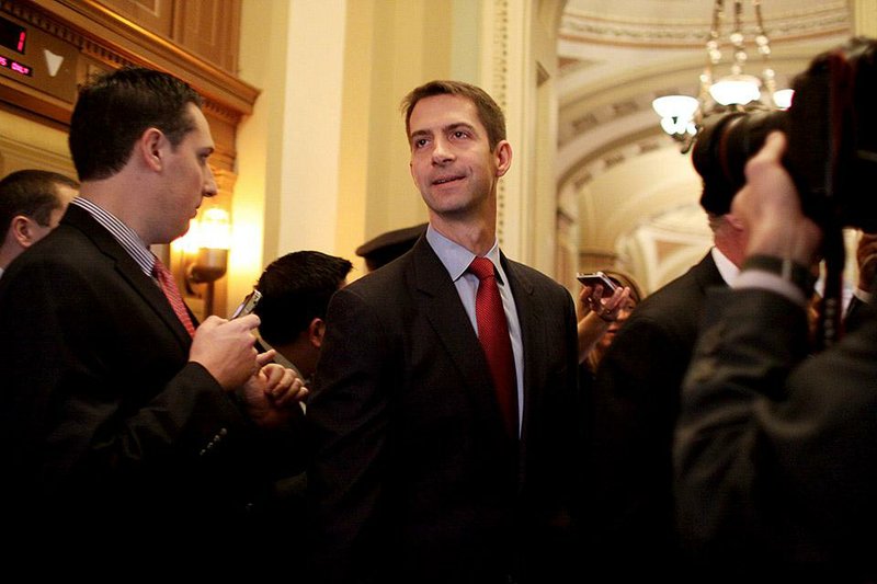 Sen-elect Tom Cotton (center), R-Ark. makes his way through reporters on Capitol Hill in Washington, Wednesday, Nov. 12, 2014. 