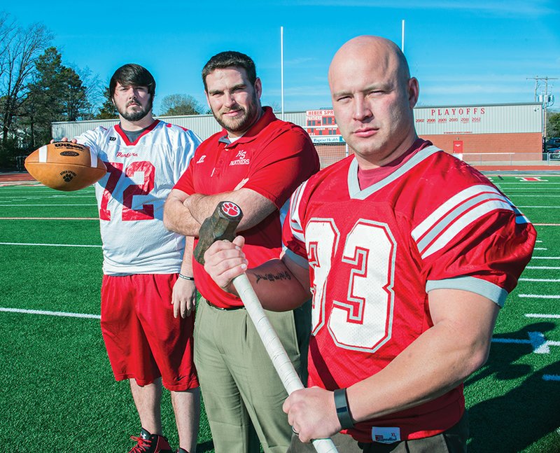 Landon Glover, from left, Heber Springs head football coach David Farr and Jacob McCormick put on their game faces while standing in the middle of the field where the Heber Springs Old Timers Football Game will be held Jan. 24. McCormick said no one is sure when the traditional yearly contest began, but he has heard from more than one player that they played in the Old Timers game in the 1970s.