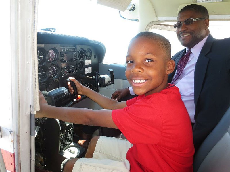 Terence Bolden, president of the nonprofit Milton P. Crenchaw Aviation Training Academy, here with nephew Phillip Johnson, 9, says getting the academy off the ground has had its challenges but has benefited from “a solid online database of contacts who have supported us to get up and going.” 
