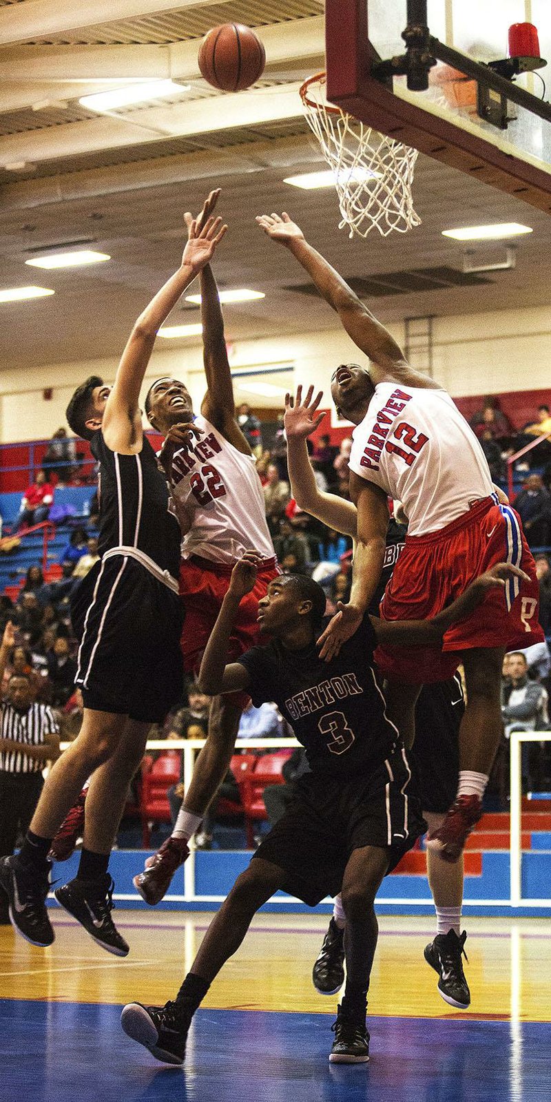 Little Rock Parkview’s Javon Franklin (22) and Jaylen Franklin (12) battle for a rebound with Shaheed Halk (3) and Jake Scoggins during a game Friday night at Ripley Arena in Little Rock.