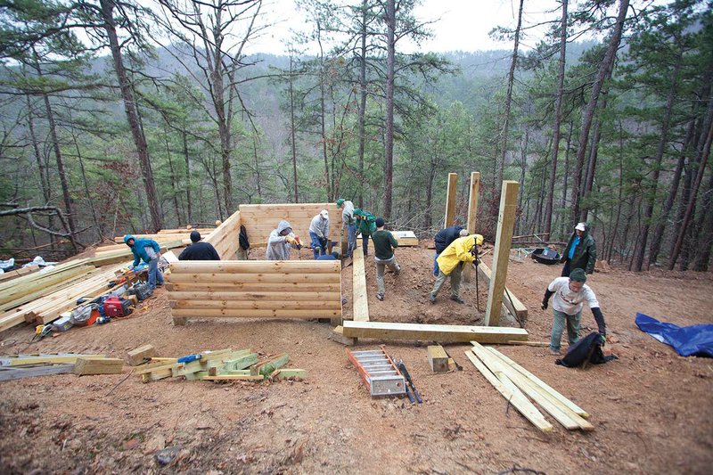 Volunteers with the Friends of the Ouachita Trail work to complete a camp shelter near Mile 101 of the Ouachita Trail. The group recently won the Volunteer Program Group award for maintenace and project efforts.