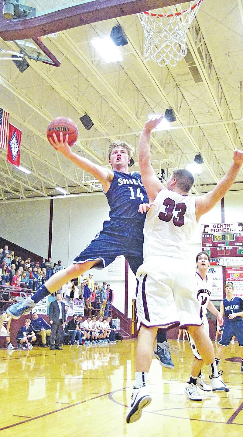  Staff Photo Randy Moll Hunter Wilson of Shiloh Christian shoots over Gentry&#8217;s Mark White during Friday&#8217;s game in Gentry.