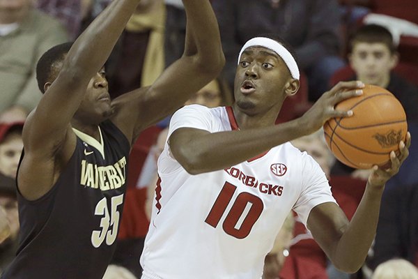 Arkansas' Bobby Portis (10) tries to pass around Vanderbilt's James Siakam (35), of Cameroon, in the first half of an NCAA college basketball game in Fayetteville, Ark., Saturday, Jan. 10, 2015. (AP Photo/Danny Johnston)