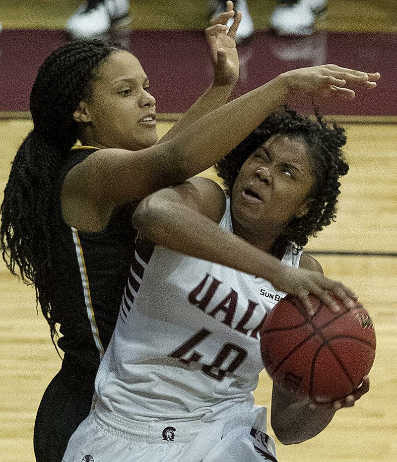 UALR forward Kaitlyn Pratt (40) tries to shoot around Appalachian State defender Bria Huffman during Saturday’s game at the Jack Stephens Center in Little Rock. Pratt finished with 12 points and the Trojans won 69-48. 