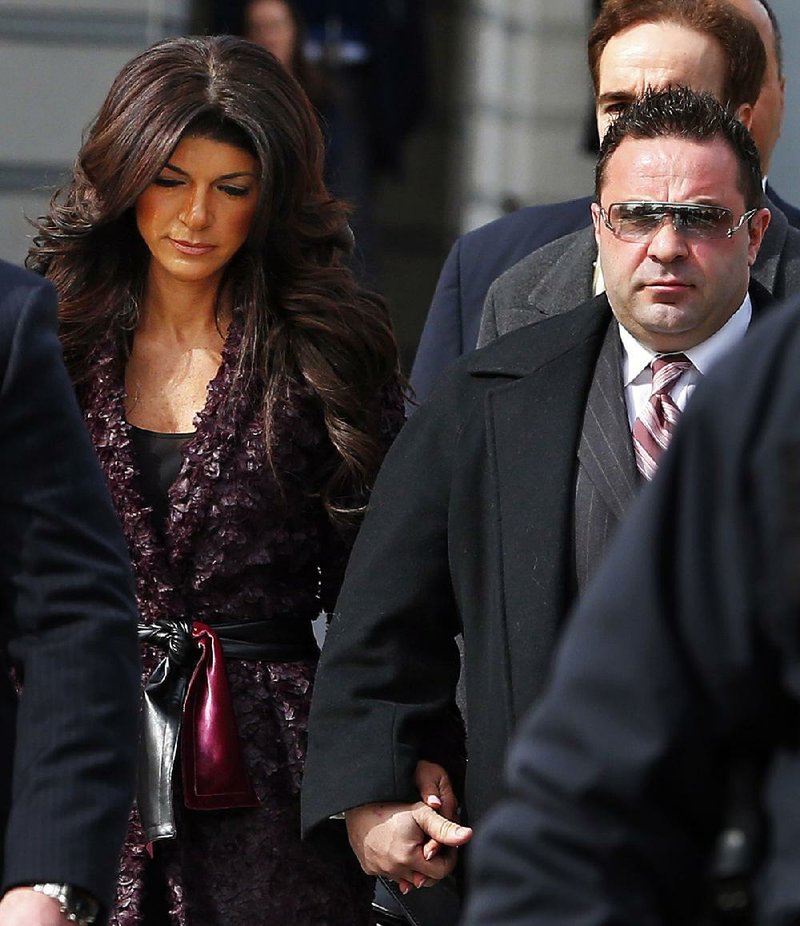 Teresa, left, and Joe Giudice, from ‚ÄúThe Real Housewives of New Jersey,‚Äù leave federal court in Newark, N.J. on Tuesday, March 4, 2014. They each pleaded guilty to several counts including bankruptcy fraud, conspiracy to commit mail fraud and wire fraud, and failing to pay taxes. (AP Photo/Rich Schultz)