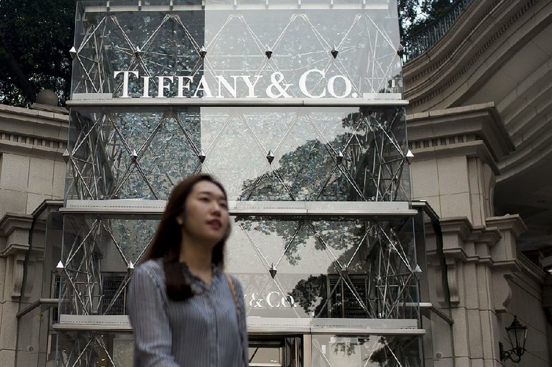 A pedestrian walks past a Tiffany & Co. store on Canton Road in the Tsim Sha Tsui area of Hong Kong, China, on Wednesday, Oct. 15, 2014. Hong Kong police said they would investigate a complaint alleging excessive use of force against a pro-democracy protester, after they used pepper spray and batons to retake a key road in seeking an end to an almost three-week occupation of parts of the city. Photographer: Brent Lewin/Bloomberg