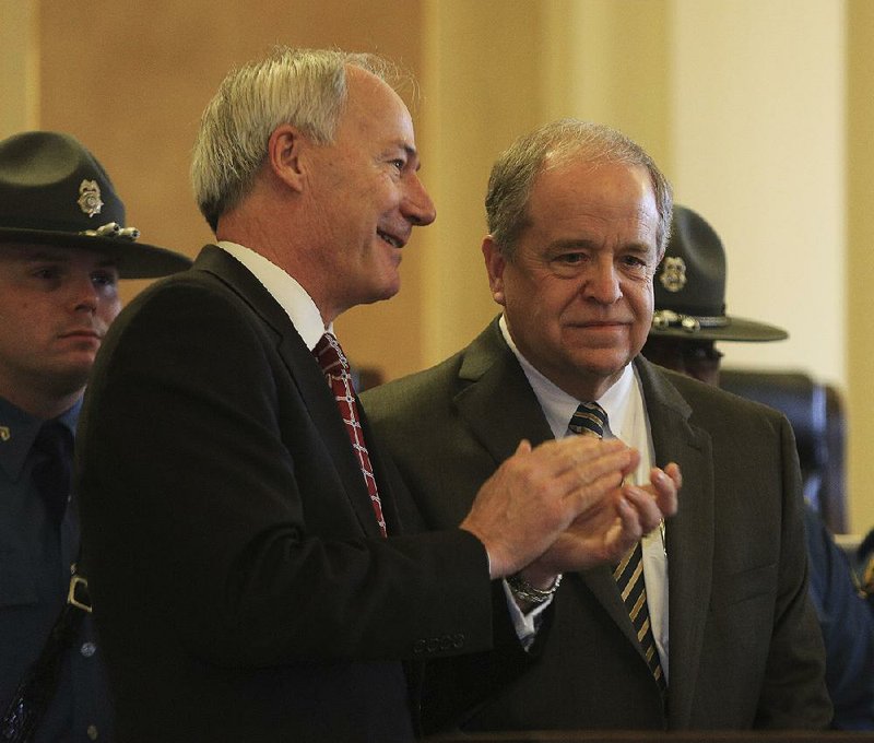 Arkansas Democrat-Gazette/STATON BREIDENTHAL --1/12/15-- New Arkansas State Police Director Bill Bryant (right) talks with Governor-elect Asa Hutchinson Monday after being taking his oath in the Old Supreme Court Chamber at the Capitol. 