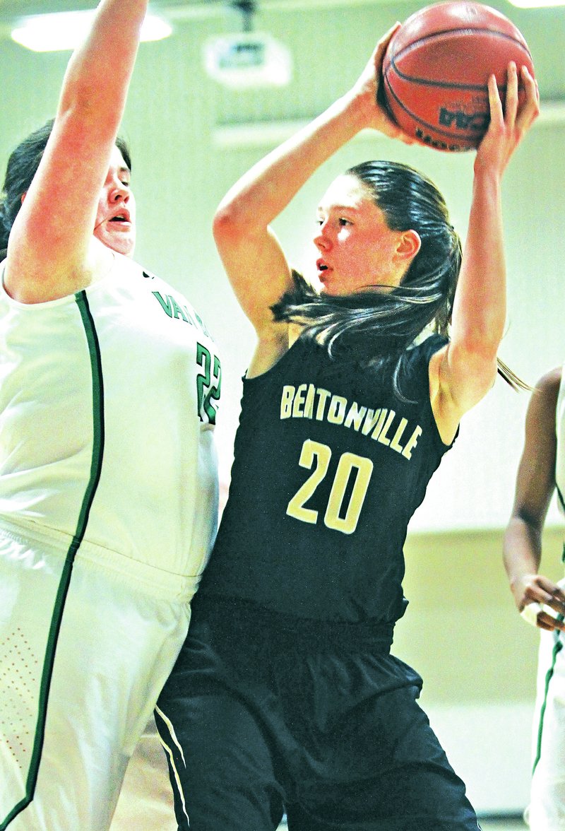 File Photo Maren Johnston, right, of Bentonville looks to pass Dec. 30 around MaKenzie Glassco of Van Buren during the Neosho Holiday Classic in Neosho, Mo.