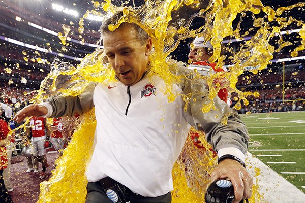 Ohio State head coach Urban Meyer is dunked during the NCAA college football playoff championship game against Oregon Monday, Jan. 12, 2015, in Arlington, Texas. Ohio State won 42-20. (AP Photo/Sharon Ellman, Pool)