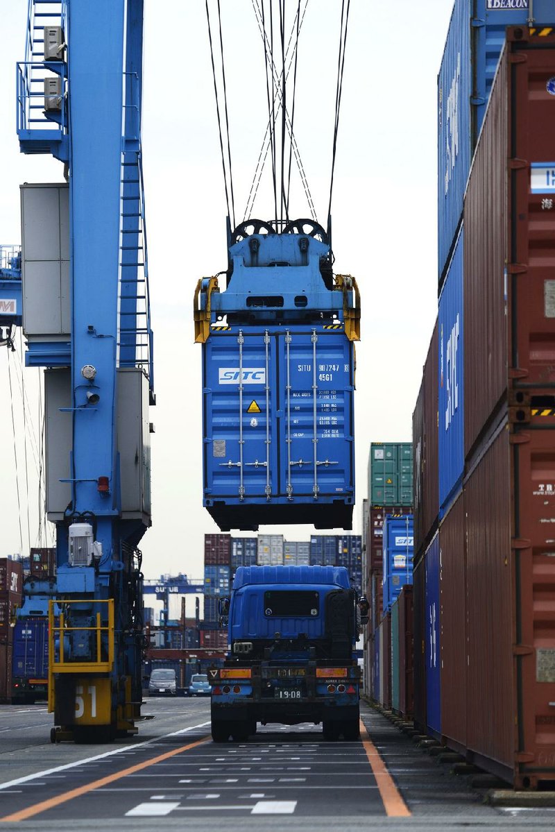 A shipping container is loaded onto a truck at a terminal in Yokohama, Japan last month. Japan is one of the 12 countries that would be part of the Trans-Pacific Partnership trade deal. 